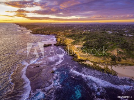 Picture of Aerial view of rugged ocean coastline with rural houses in the distance at dusk Melbourne Australia